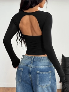 Y2K style backless long sleeve crop top in solid black with cut-out design details