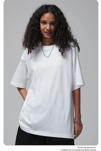 Detailed texture of white heavyweight cotton oversized t-shirt with retro slogan