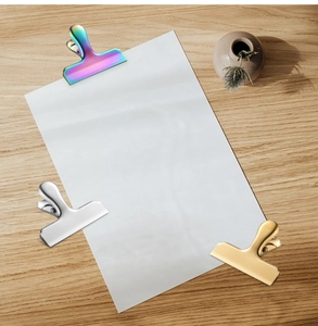 Close-up of T-shaped stainless steel sealing clips in gold, silver, and iridescent finishes