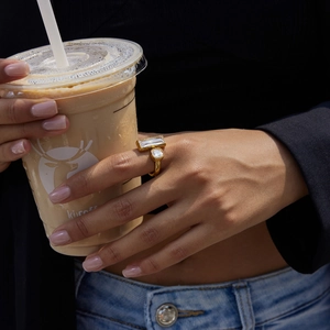 Detail of 18K gold-plated open ring featuring dual white cubic zirconia stones on hand