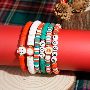 5-piece Christmas beaded bracelet set with JOY and MERRY charms on red display