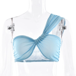 Detail of light blue mesh one-shoulder top showing pleated texture and asymmetric design