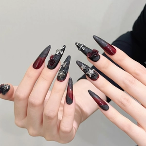 Gothic stiletto press-on nails with dark red roses, silver crosses and black grainy texture