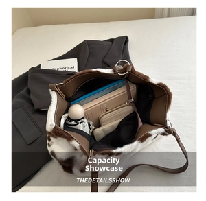 Detailed interior of a fluffy cow print tote bag showing spacious capacity for daily items