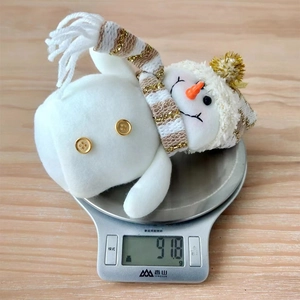 Detailed view of snowman plush on a digital scale showing weight of 91.8g