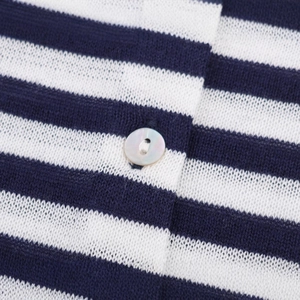 Close-up of blue and white striped knit cardigan with a mother-of-pearl button detail