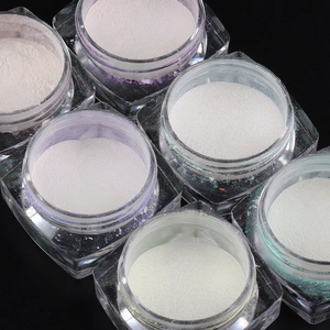 Detailed macro view of 6 jars of aurora pearl nail powders for DIY chrome nail art