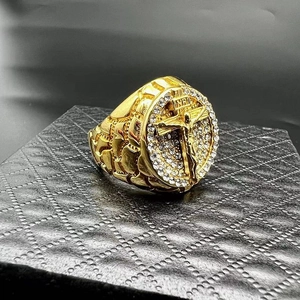Macro shot of gold hip-hop ring with crucifix relief and pave-set white rhinestones