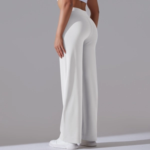 Detail view of white high-waisted wide-leg yoga pants with side pockets and smooth drape
