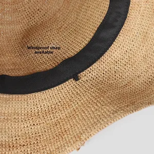 Detail of raffia sun hat featuring an inner sweatband and a windproof rope hook