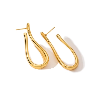 Detail view of gold irregular streamline earrings with high-polished mirror finish