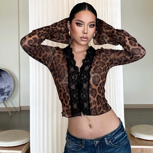 Close-up of leopard print top with delicate black lace trim and sharp textile texture