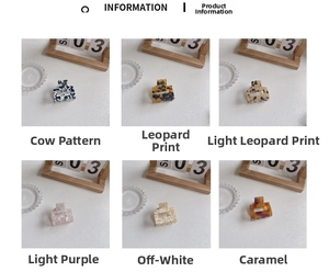 Detail view of 6 small square acetate hair claws in cow, leopard, and marble patterns