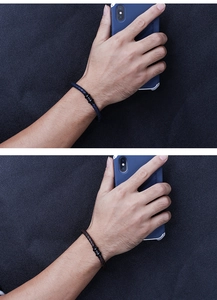 Detail showing woven leather bracelets in navy blue and brown with black metal rings