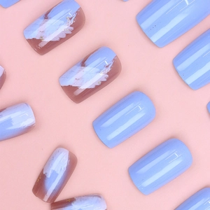 Detailed view of short square press-on nails with purple marble design and gold foil flakes