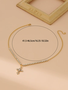 Detail view of gold cross pendant necklace with length dimensions 41.5 to 46.5cm