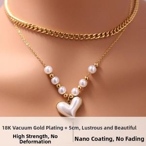 Detail of 18K vacuum gold plated layered necklace with pearls and heart pendant