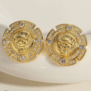 Detailed close-up of gold lion head earrings with white crystal pave in vintage style