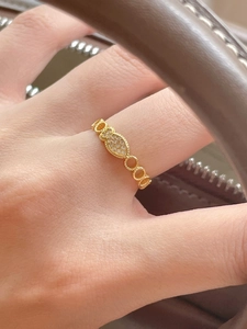 Close-up of gold hollow ring with marquise-shaped cubic zirconia pave setting