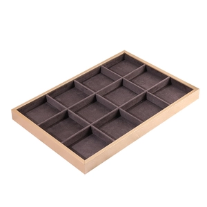 Close-up of 12-slot beige jewelry display tray with champagne gold metal frame