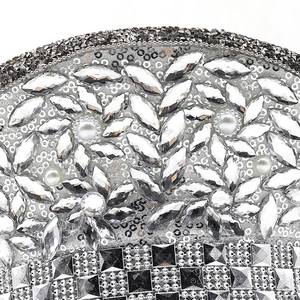 Macro detail of luxury silver sequins, rhinestones and pearls on the hip-hop cap