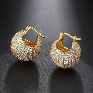 Macro detail of gold-plated hoop earrings with micro-paved sparkling cubic zirconia