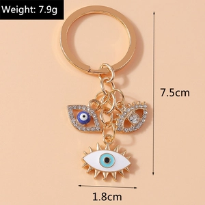 Detail view of gold devil eye keychain showing dimensions 7.5cm length and 7.9g weight