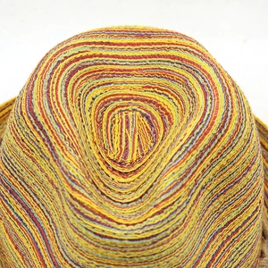 Macro shot of colorful spiral woven texture on a sun straw hat with vibrant patterns