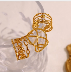 Close-up of 18K gold-plated hollow rings with star charms and floral geometric patterns