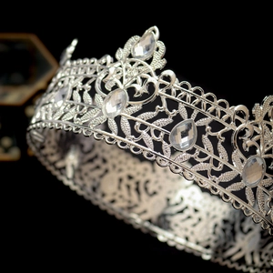 Detailed close-up of intricate silver baroque crown with crystal rhinestones and vine patterns