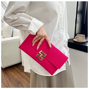 Chic rose pink felt envelope clutch with gold buckle and crocodile texture in hand