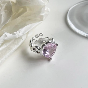 Close-up of S925 silver ring featuring a pink heart-shaped gemstone on white silk