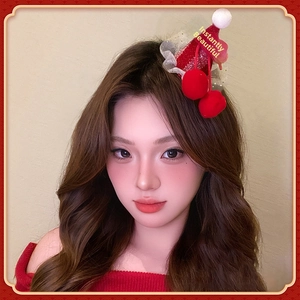 Detail of red sequined mini hat hair clip with plush pom poms and cherry accents