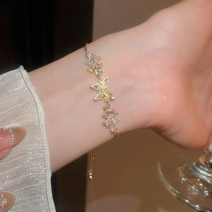 Detailed close-up of 18k gold-plated butterfly bracelet with shimmering zircon stones