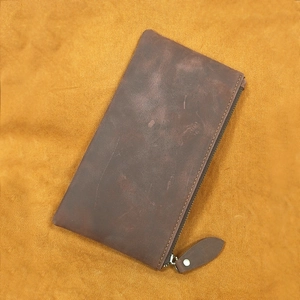 Detailed view of deep brown crazy horse leather long wallet with vintage zipper closure