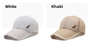 Detail of white and khaki mesh baseball caps featuring bronze metal feather emblems