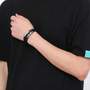 Men's multilayer leather bracelet with skull beads and magnetic buckle on wrist