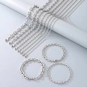 Close-up of various stainless steel cable chains and bracelets with lobster clasps