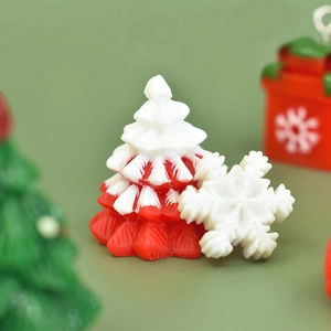 Macro detail of red and white resin Christmas tree and sparkling snowflake ornaments