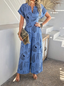 Blue V-neck short sleeve jumpsuit with black abstract geometric patterns and waist tie