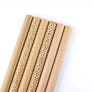 Detail showing 6 rolls of brown kraft wrapping paper with black and white geometric patterns