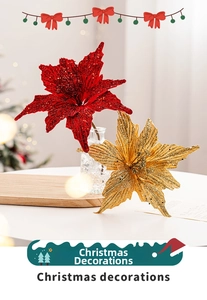 Close-up of sparkling artificial poinsettia flowers in red and gold for Christmas decor