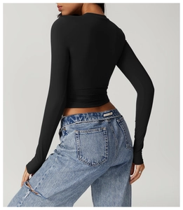 Slim fit black long sleeve yoga top back view showing athletic cut and cropped hem