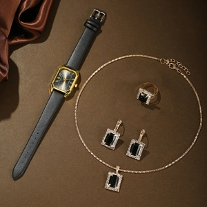 Close-up of gold square quartz watch with matching black gemstone jewelry set for women