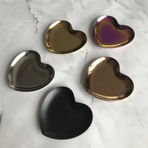 Top view of heart-shaped stainless steel trays in gold, silver, rose gold, and black