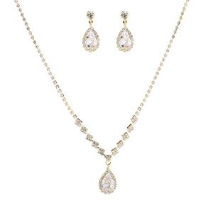 Close-up of sparkling cubic zirconia bridal jewelry set with gold teardrop pendants
