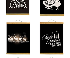 Detail of four Christmas DIY glowing hanging paintings with wooden scrolls and canvas