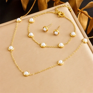 Elegant gold pearl jewelry set including necklace, bracelet and stud earrings