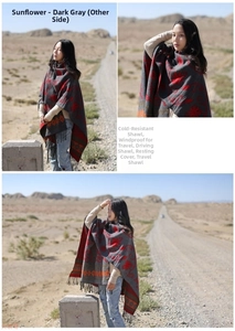 Detail of dark grey ethnic shawl with red sunflower patterns and fringed edges