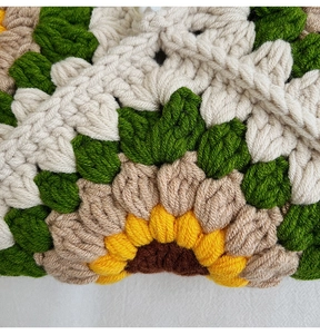 Close-up of handmade crochet sunflower bag showing detailed yellow yarn knit textures